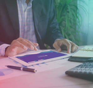 An octopus wearing glasses working at a computer with data dashboards on screens.